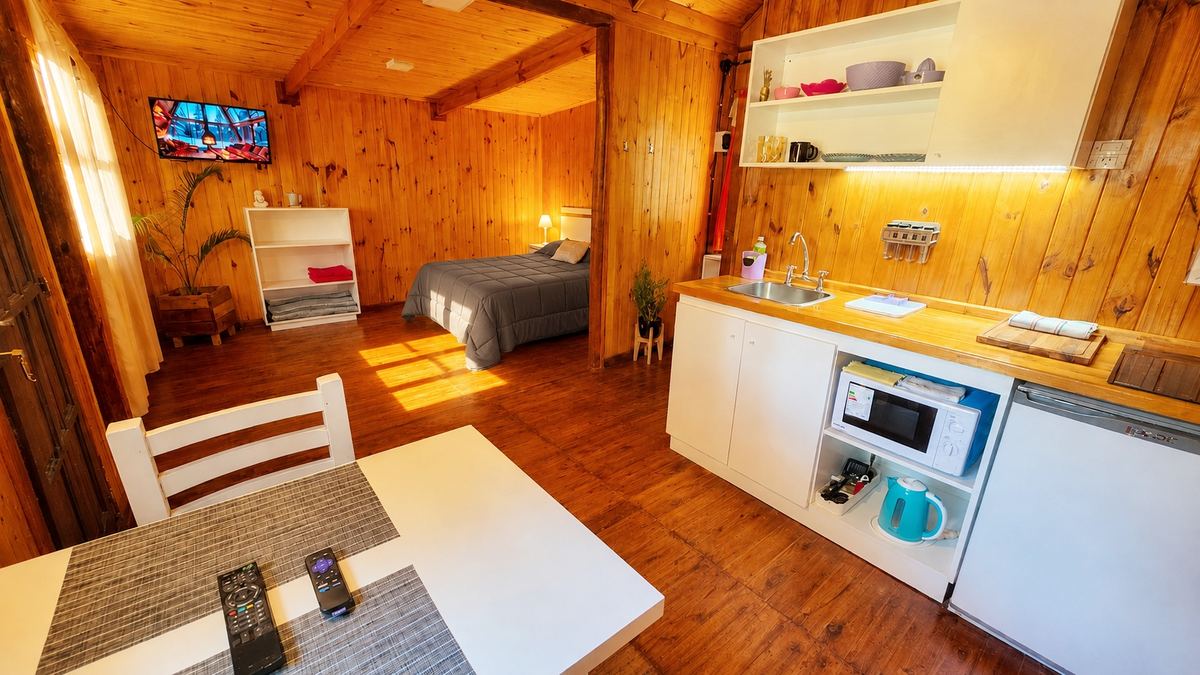El ambiente, con la cocina y la cama al fondo
